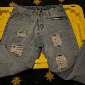 Denim blue jeans with holes